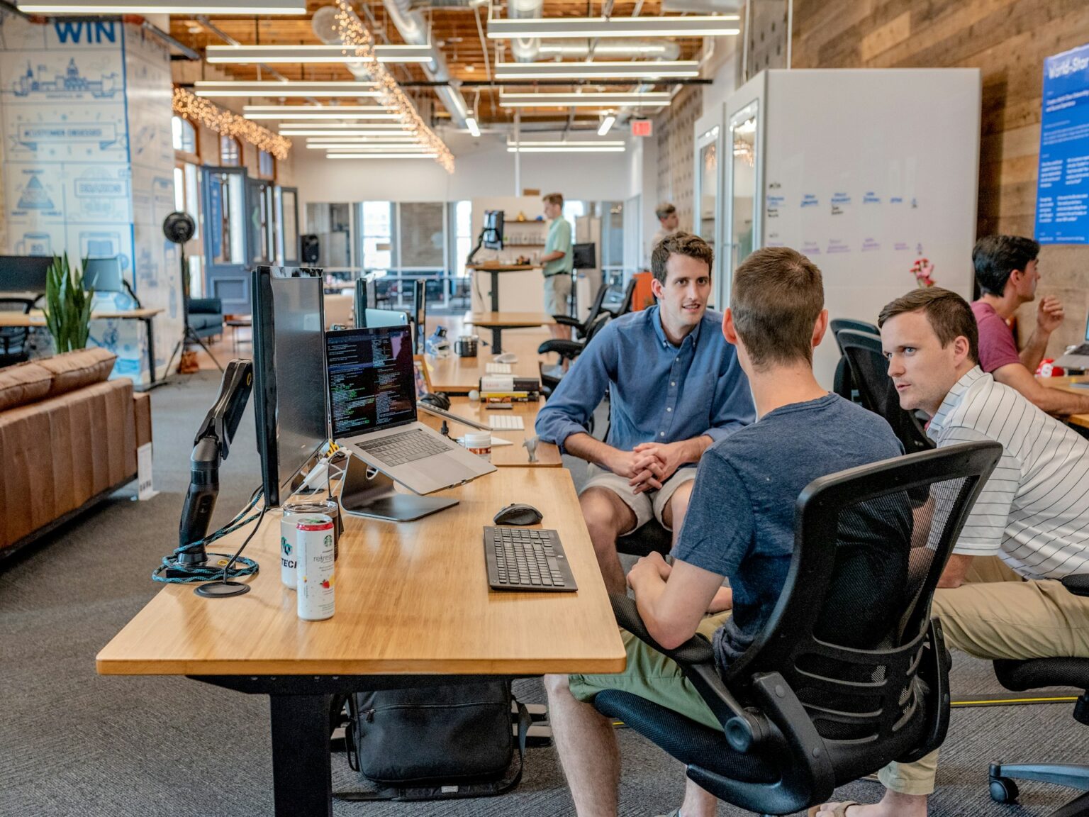 a group of men sitting at a desk